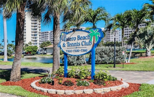 community / neighborhood sign with a water view