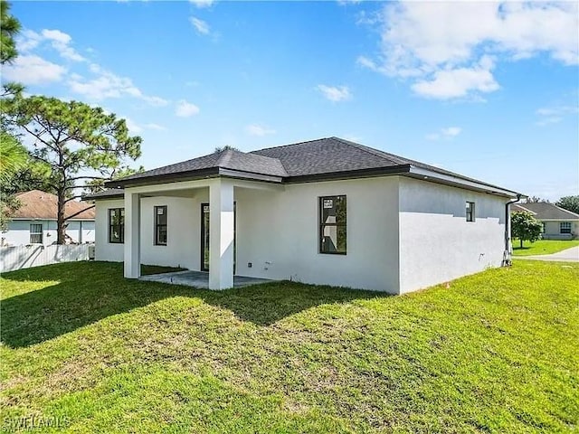 rear view of property with a patio area and a yard