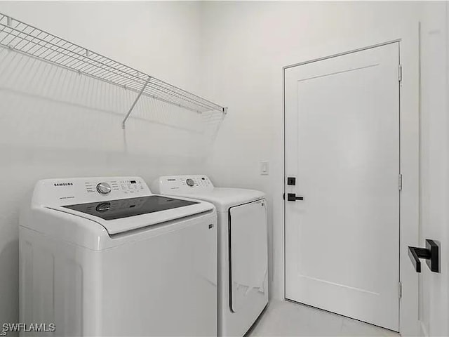 washroom with separate washer and dryer