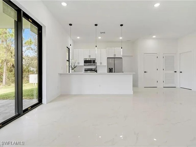 unfurnished living room featuring sink