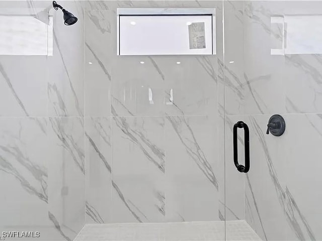 interior details featuring an enclosed shower