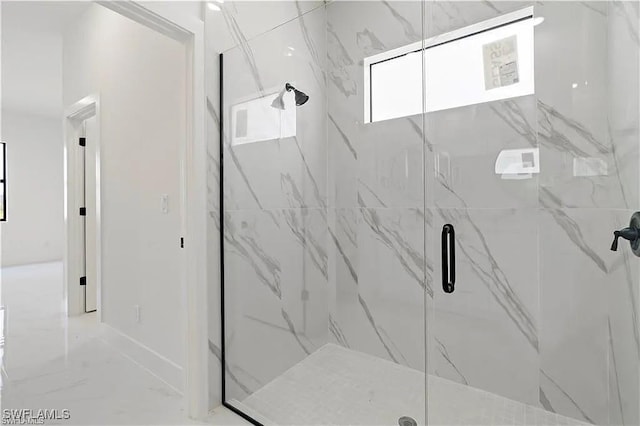 bathroom with a shower with door