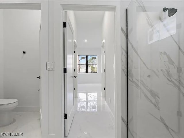 bathroom with toilet and a shower with shower door