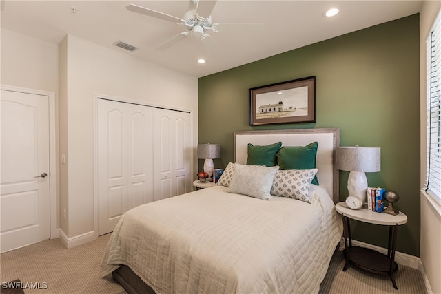 bedroom with a closet, light carpet, and ceiling fan