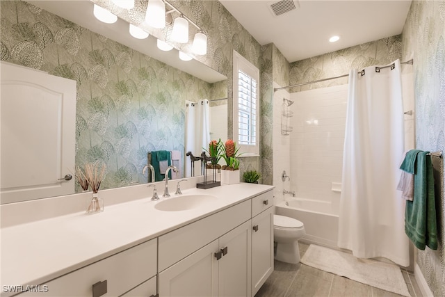 full bathroom featuring vanity, shower / bath combination with curtain, and toilet