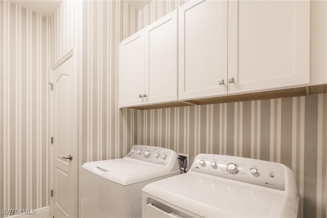 washroom with cabinets and independent washer and dryer