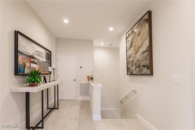 hall featuring light tile patterned flooring