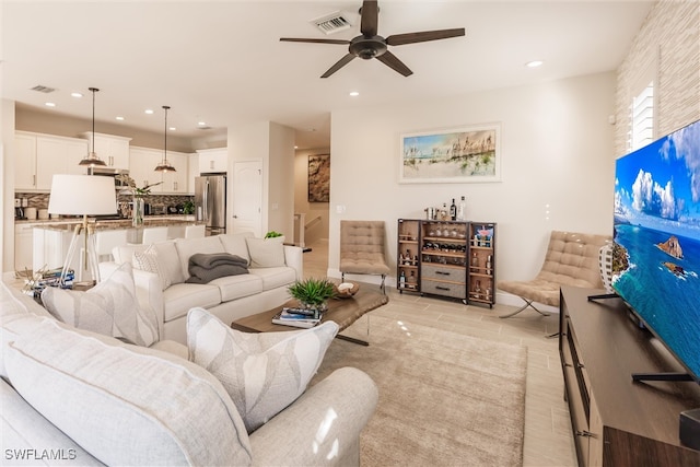 living room with ceiling fan and light tile patterned floors