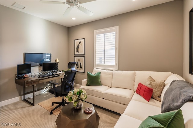 office space featuring ceiling fan and light colored carpet