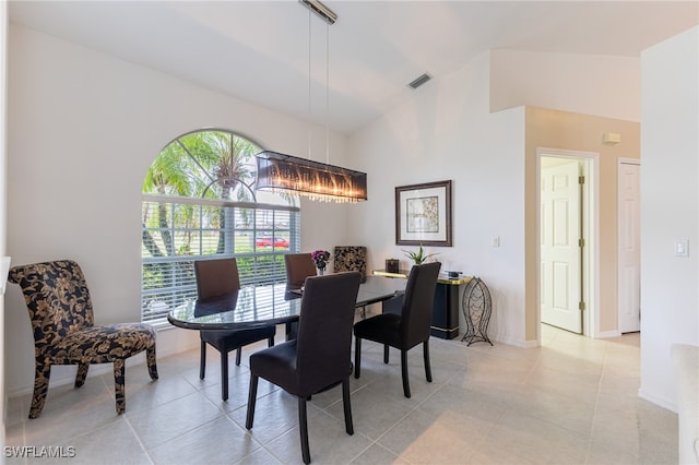 tiled dining room with vaulted ceiling