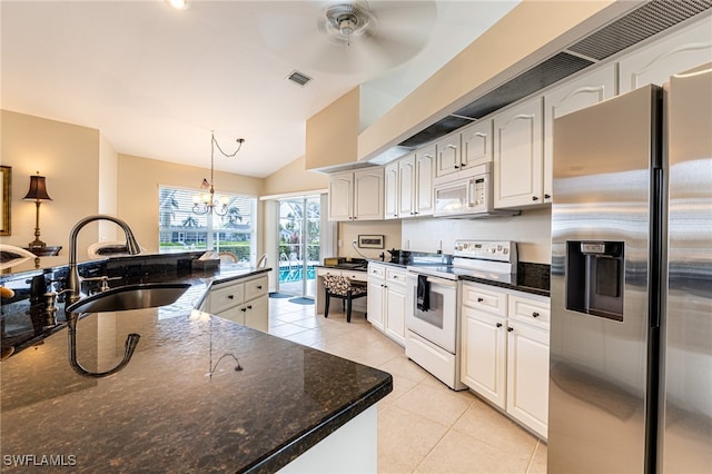 kitchen with white appliances, white cabinetry, sink, and decorative light fixtures