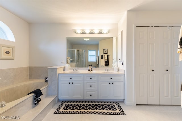 bathroom featuring a wealth of natural light, vanity, and tile patterned floors