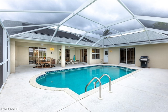 view of swimming pool with ceiling fan, a lanai, a grill, and a patio