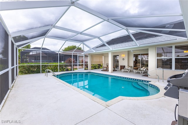 view of swimming pool with a lanai and a patio area