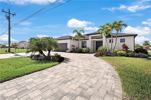 view of front of property with a garage and a front lawn