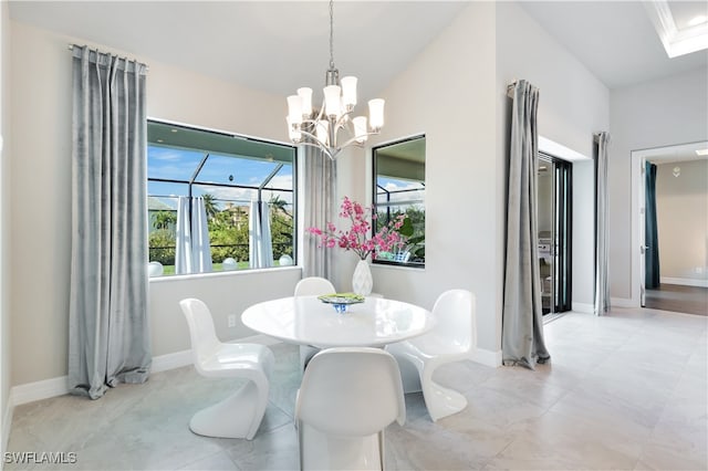 dining area with a chandelier and vaulted ceiling