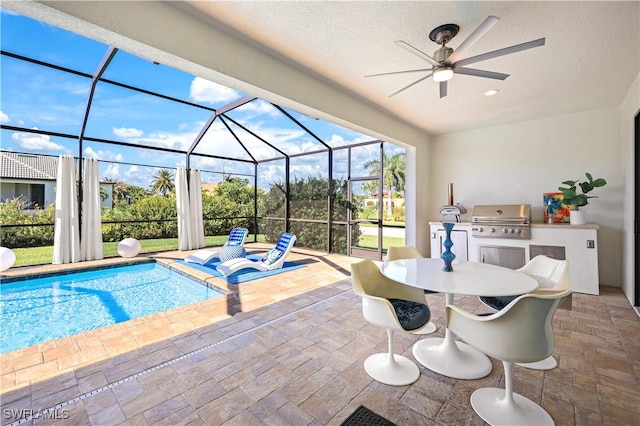 view of swimming pool featuring ceiling fan and grilling area