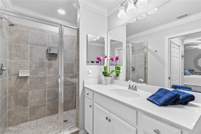 bathroom with an enclosed shower, vanity, ceiling fan, and crown molding