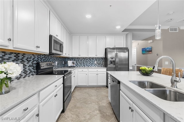 kitchen with stainless steel appliances, sink, backsplash, white cabinetry, and decorative light fixtures