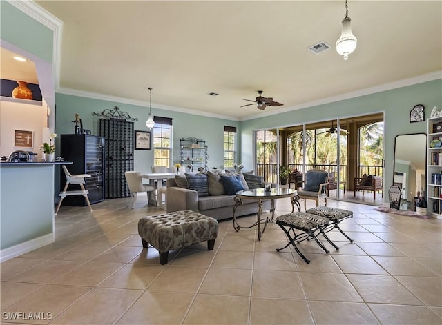 tiled living room featuring ceiling fan and ornamental molding