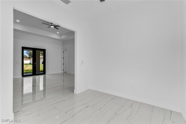 spare room featuring french doors and ceiling fan