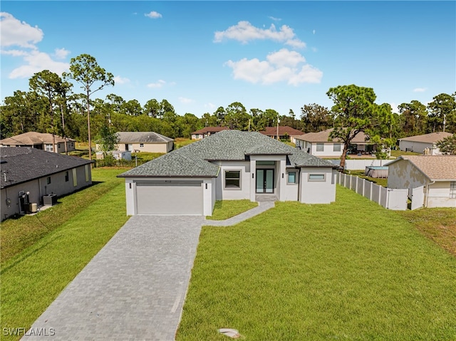 view of front of property with a garage and a front lawn