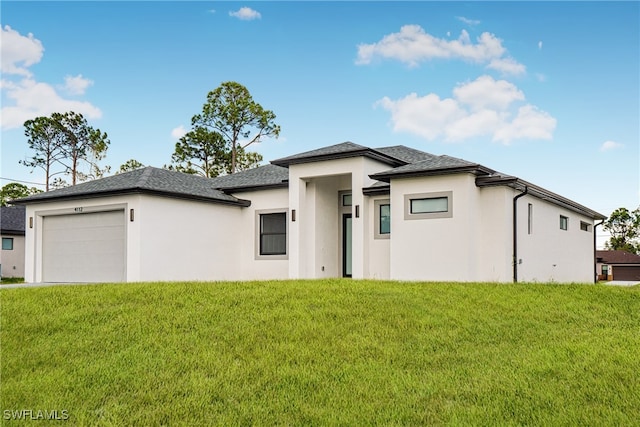 prairie-style home with a garage and a front yard