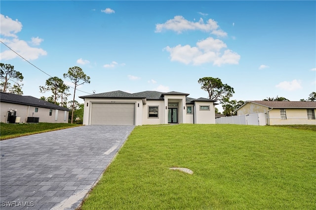 view of front of property with a garage and a front yard