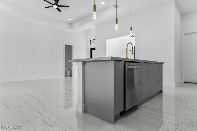 kitchen with a high ceiling, gray cabinetry, a tray ceiling, and hanging light fixtures