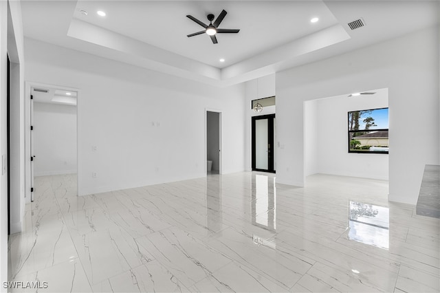 unfurnished room with french doors, ceiling fan, and a raised ceiling