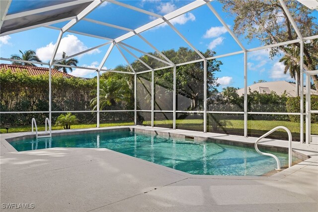 view of swimming pool featuring a patio and a lanai