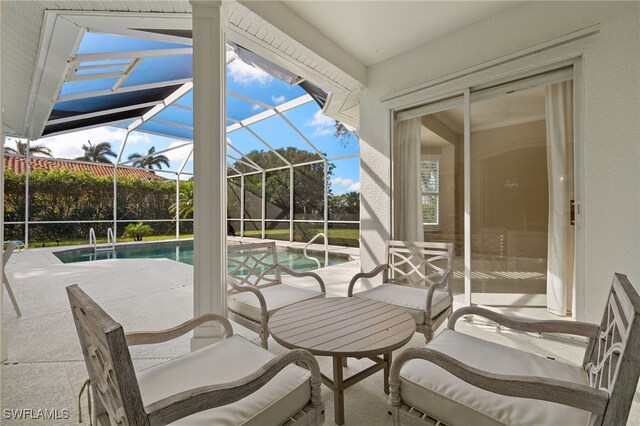 view of patio with glass enclosure