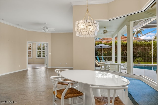 tiled dining space with baseboards, a ceiling fan, and crown molding