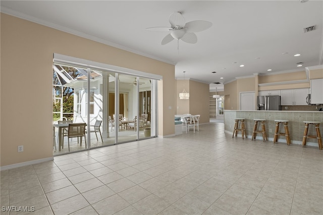 unfurnished living room with ceiling fan, crown molding, and light tile patterned flooring