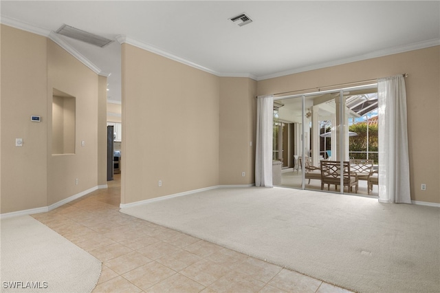 spare room with light carpet and crown molding