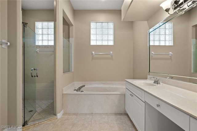 full bathroom featuring a garden tub, tile patterned floors, a shower stall, and vanity