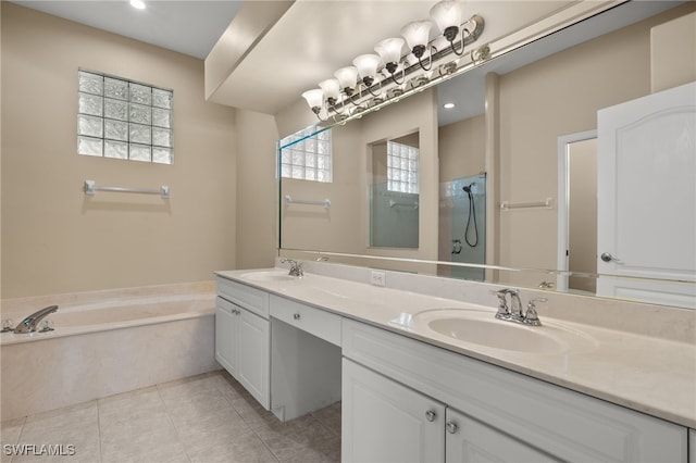 full bathroom with tile patterned flooring, double vanity, a sink, a garden tub, and a shower