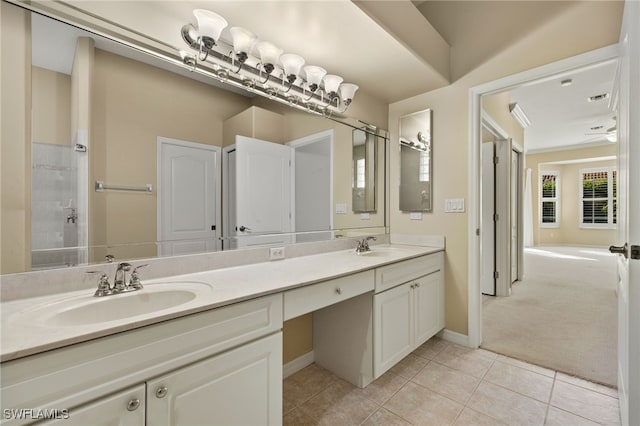 bathroom with tile patterned flooring, vanity, and ceiling fan