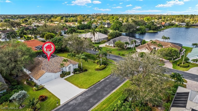 drone / aerial view featuring a residential view and a water view