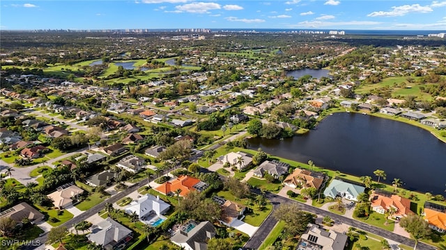 drone / aerial view with a residential view and a water view