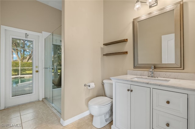 bathroom featuring a shower stall, baseboards, toilet, tile patterned floors, and vanity