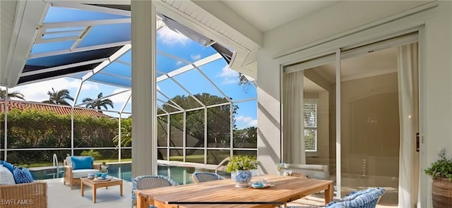 sunroom / solarium with plenty of natural light and outdoor dining area