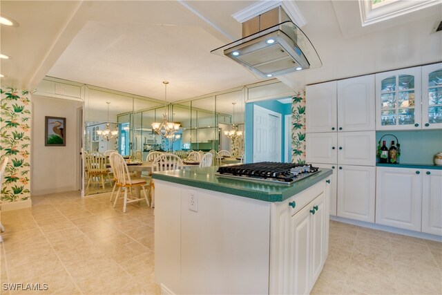 kitchen featuring white cabinetry, stainless steel gas cooktop, decorative light fixtures, and light tile patterned flooring