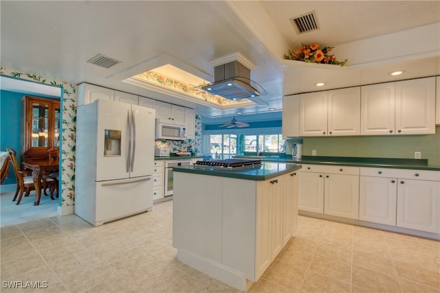 kitchen featuring white cabinetry, light tile patterned floors, white appliances, ceiling fan, and a center island