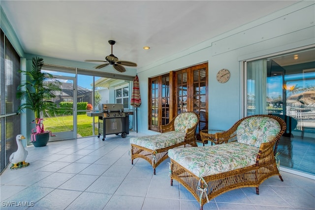 sunroom featuring ceiling fan