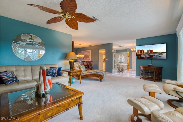 living room featuring carpet, ceiling fan with notable chandelier, and a textured ceiling