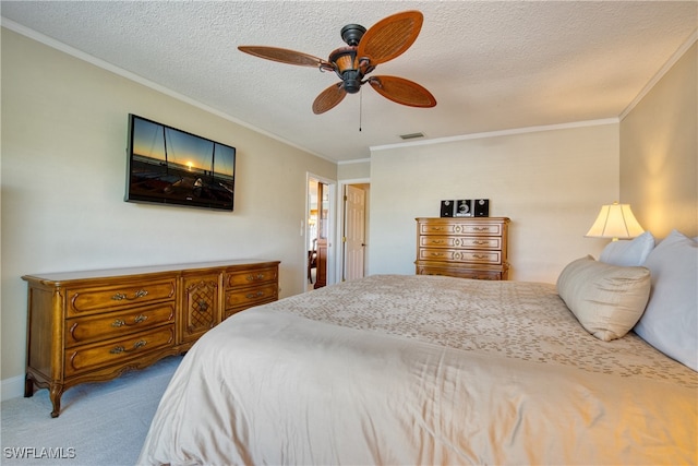 carpeted bedroom with a textured ceiling, ceiling fan, and crown molding