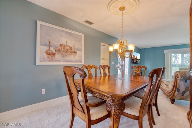 dining space with a notable chandelier and light carpet