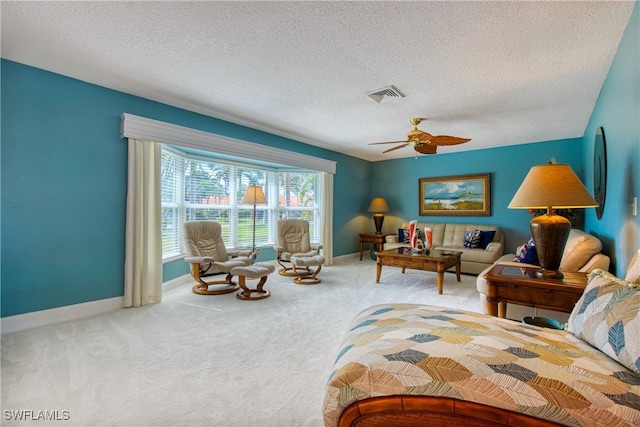 carpeted bedroom featuring a textured ceiling and ceiling fan