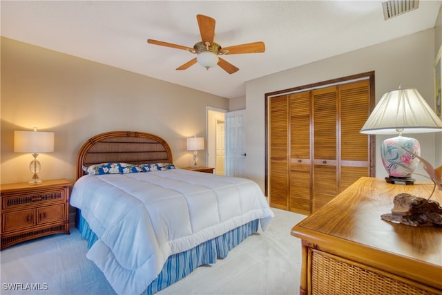 bedroom with a closet, ceiling fan, and carpet floors